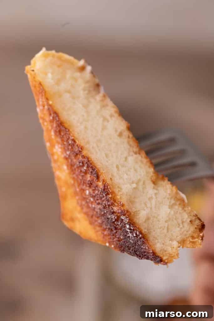 Perfect Cinnamon Sugar Toast, Every Time 3 Close-up of a piece of cinnamon sugar toast on a fork, showing its crispy, caramelized surface.