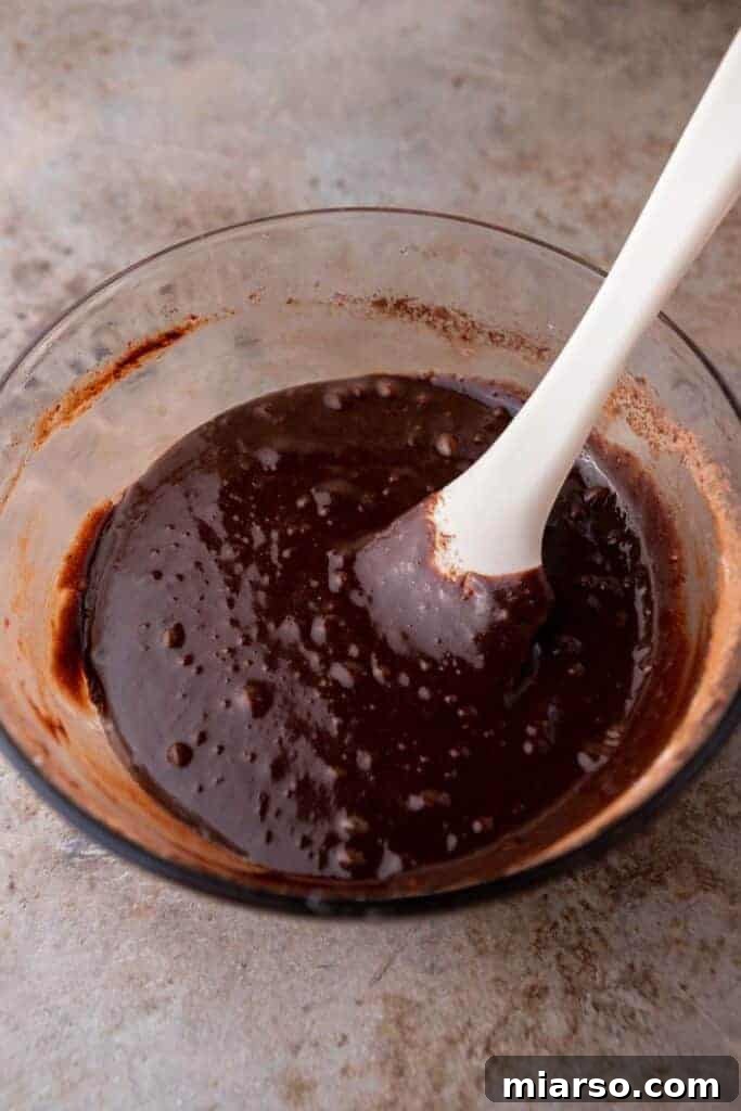 Rich chocolate brownie batter in a bowl after dry ingredients have been folded in.