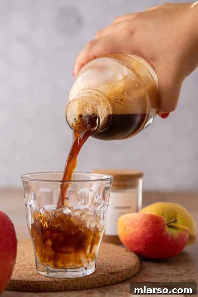 Pouring espresso over ice in a glass