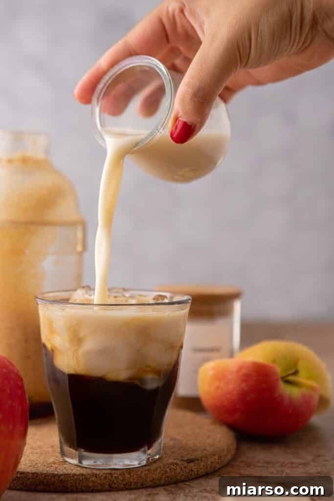Pouring oatmilk over espresso