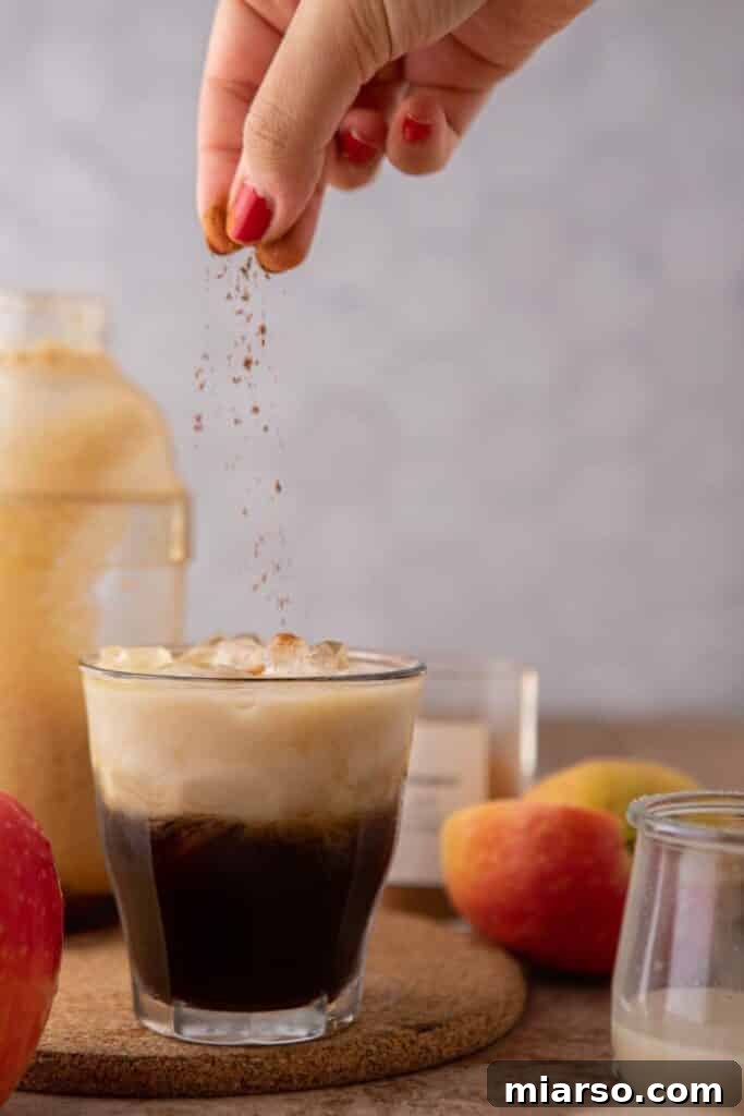 Sprinkling cinnamon over copycat Starbucks drink