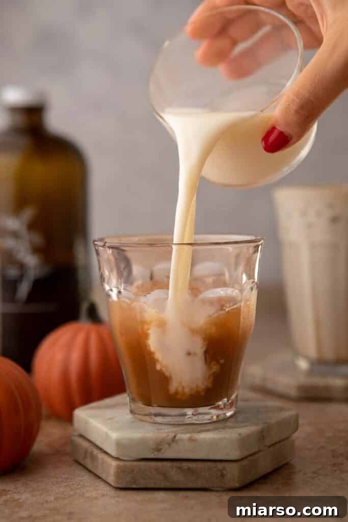 Pouring milk over chai concentrate