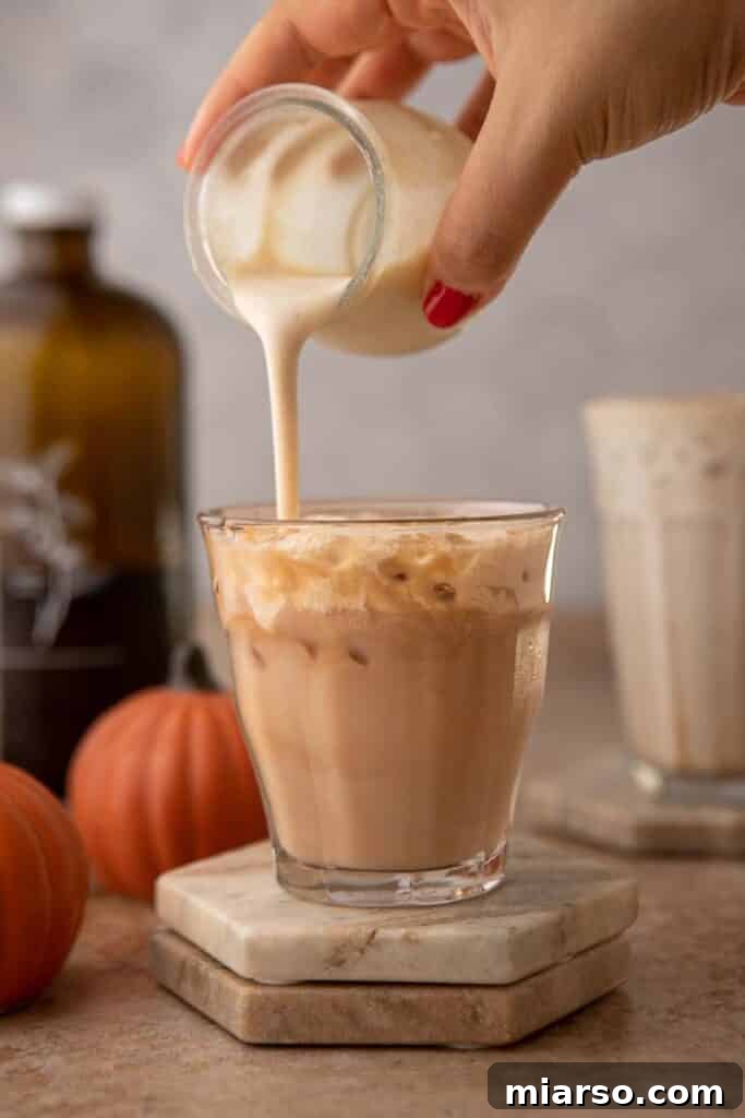 Pouring Pumpkin cold foam in a cup