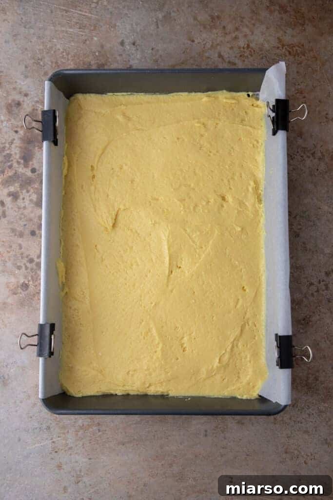 Cake batter spread in a baking pan with streusel topping