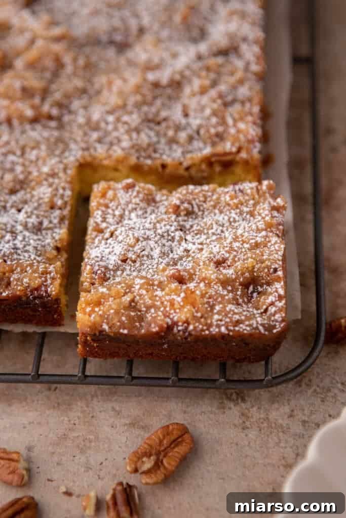 A slice of coffee cake cooling on a wire rack