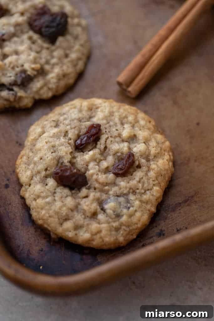 Classic Quaker oatmeal cookie recipe on a wire rack with a glass of milk