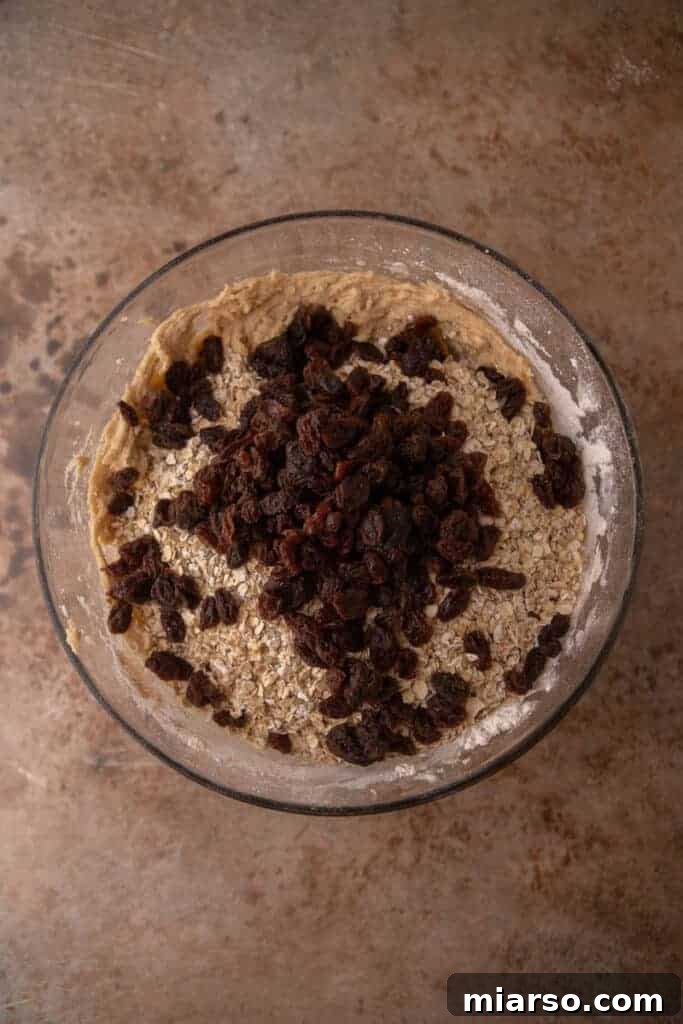 Oatmeal raisin cookie dough in a mixing bowl