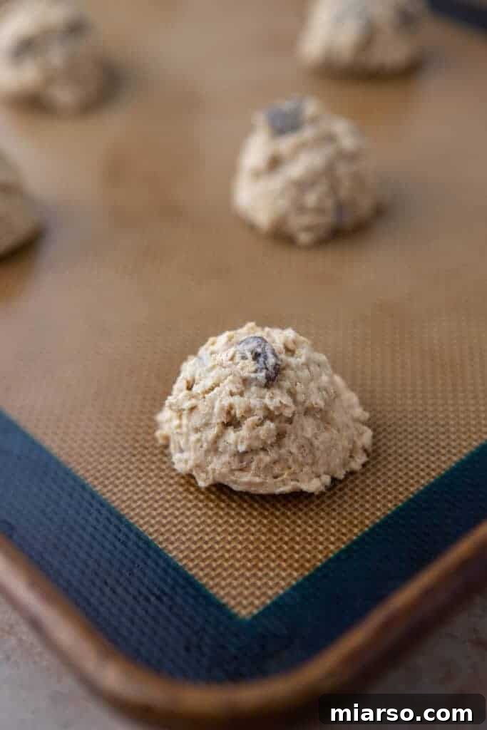Unbaked cookie dough portions on a baking sheet