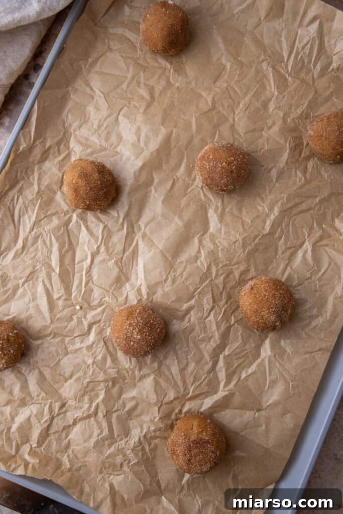 More cookie dough balls on a baking sheet, ready for the oven