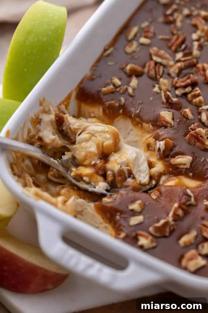 A beautifully presented caramel apple dip recipe with various dippers, ready for a fall gathering.