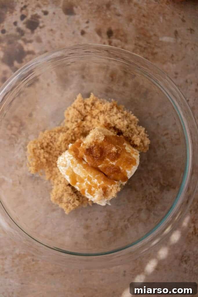 Wet ingredients for the cheesecake dip in a mixing bowl before combining.