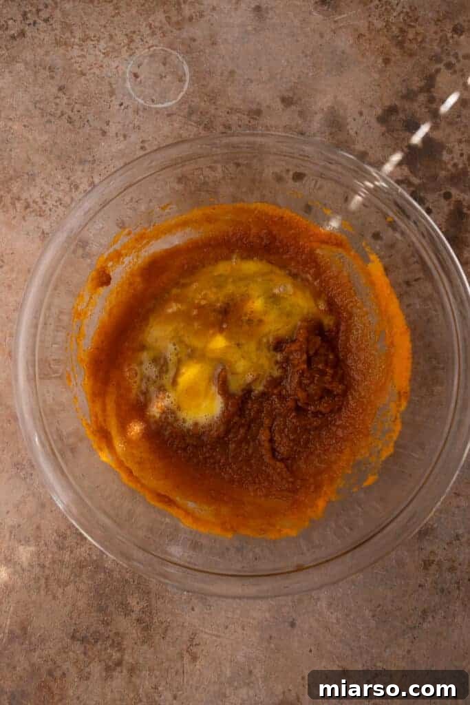 Bite-Sized Pumpkin Delights in a Muffin Tin 6 Mixed ingredients in a bowl, a creamy orange pumpkin filling starting to take shape.