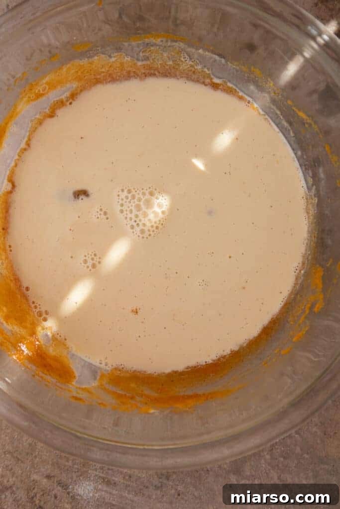 Bite-Sized Pumpkin Delights in a Muffin Tin 7 Ingredients fully mixed into the bowl, showing a smooth, consistent pumpkin custard ready for baking.