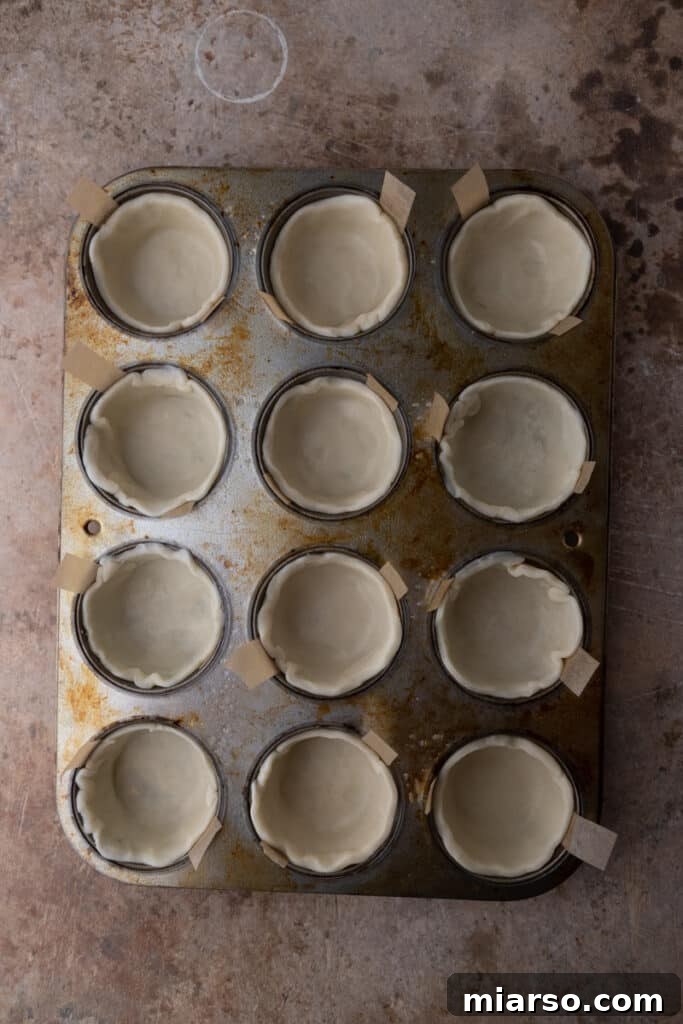 empty pie shells in a muffin tin