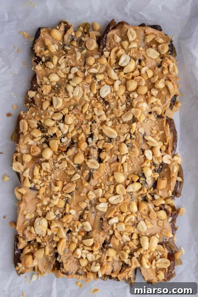 Dates with peanut butter and chopped peanuts on top