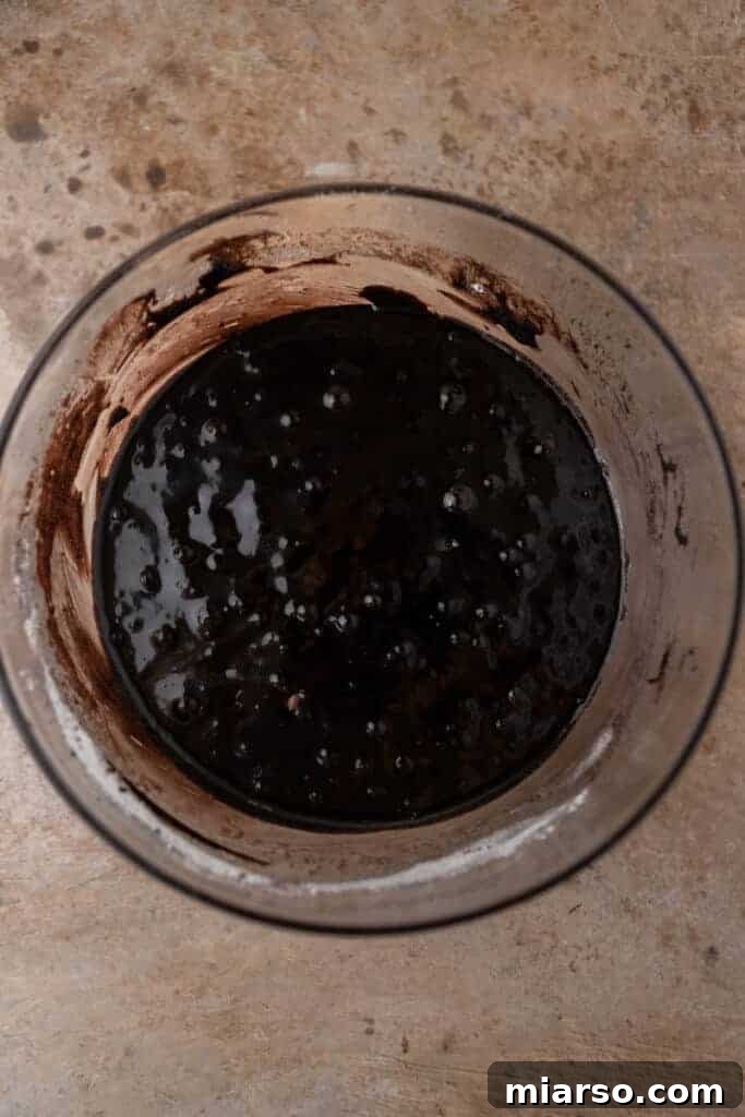 Dark cocoa brownie batter in a bowl