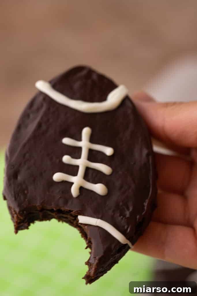 Hand holding a perfectly decorated football brownie