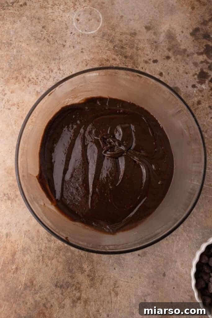 Brownie batter being mixed in a bowl