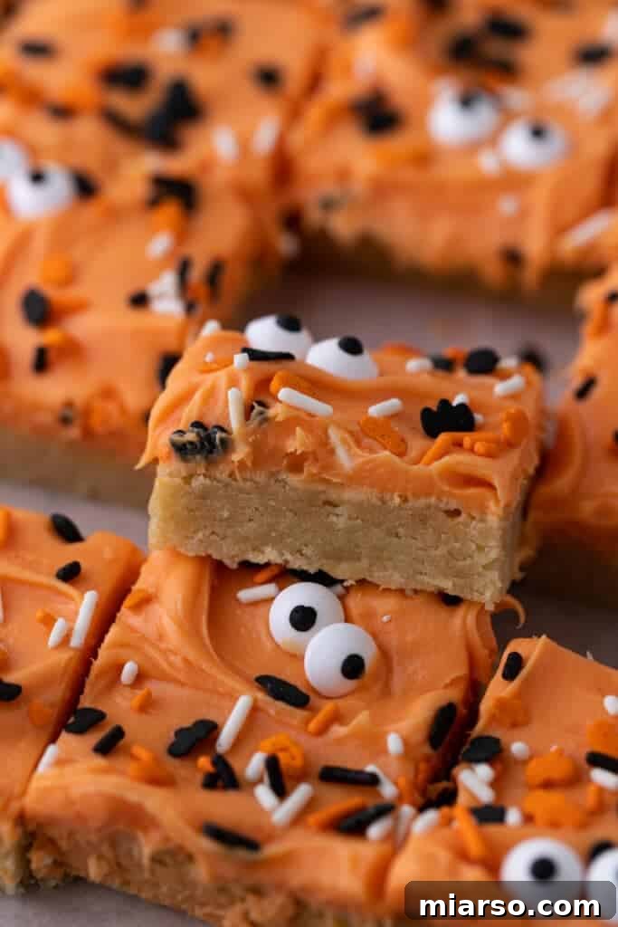 Spooktacularly Simple Halloween Sugar Cookie Bars 2 Halloween sugar cookie bars ready to be served on a spooky background