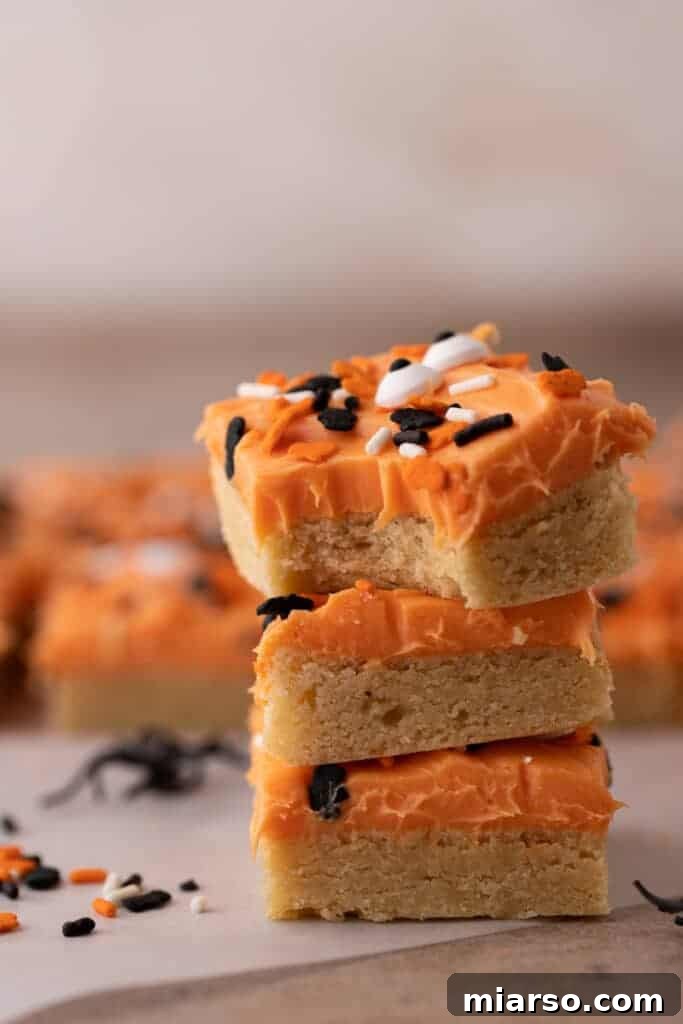 Spooktacularly Simple Halloween Sugar Cookie Bars 12 A stack of Halloween sugar cookies ready to be stored