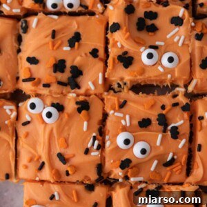 Spooktacularly Simple Halloween Sugar Cookie Bars 13 Halloween sugar cookie bars with orange frosting and spooky decorations