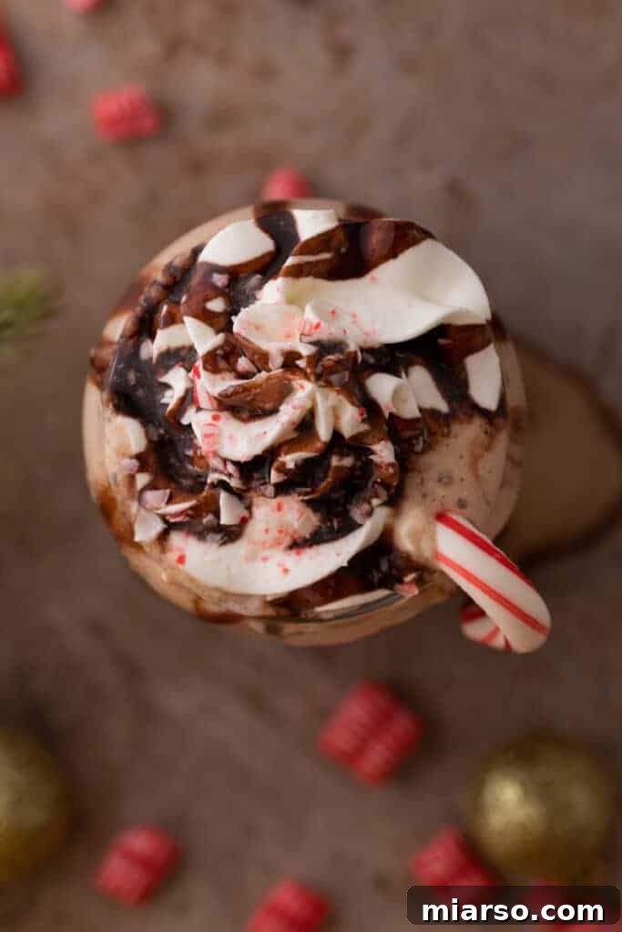 An overhead shot of a delicious Peppermint Mocha Frappe topped with whipped cream and sprinkles.