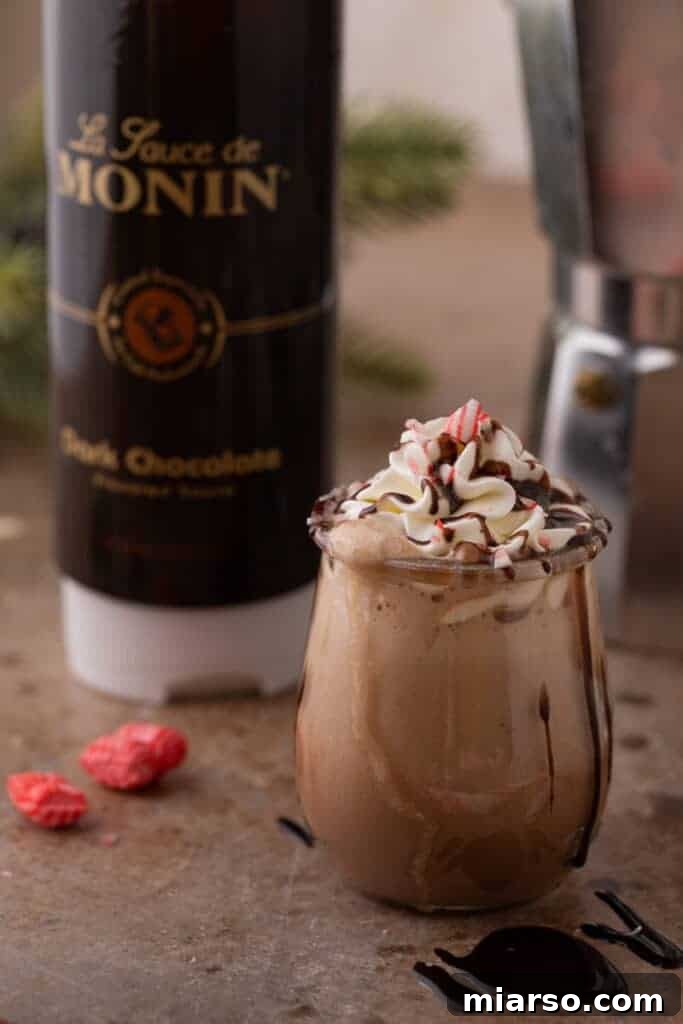 A small cup of Peppermint Mocha Frappuccino, ready to be enjoyed.