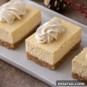 Decadent eggnog cheesecake bars on a plate
