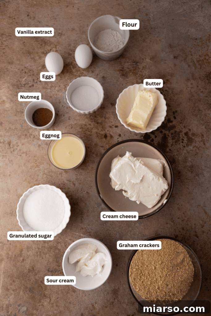 Assortment of fresh ingredients for eggnog cheesecake bars on a rustic wooden surface