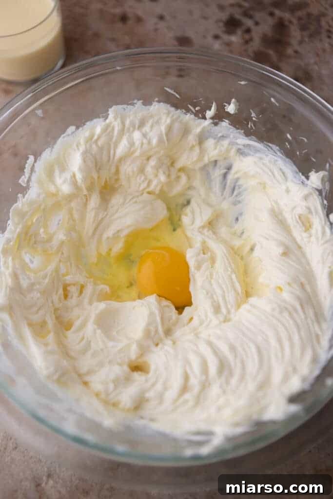 Creamed cream cheese and egg in a bowl, showing the smooth mixture