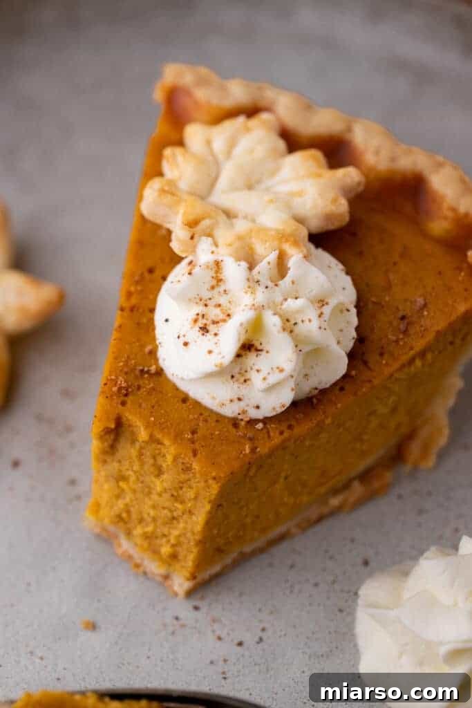 Double the Delight: The Ultimate 9-Inch Pumpkin Pie Recipe 13 A slice of pumpkin pie with a delicious bite taken out, highlighting the creamy filling and golden crust.