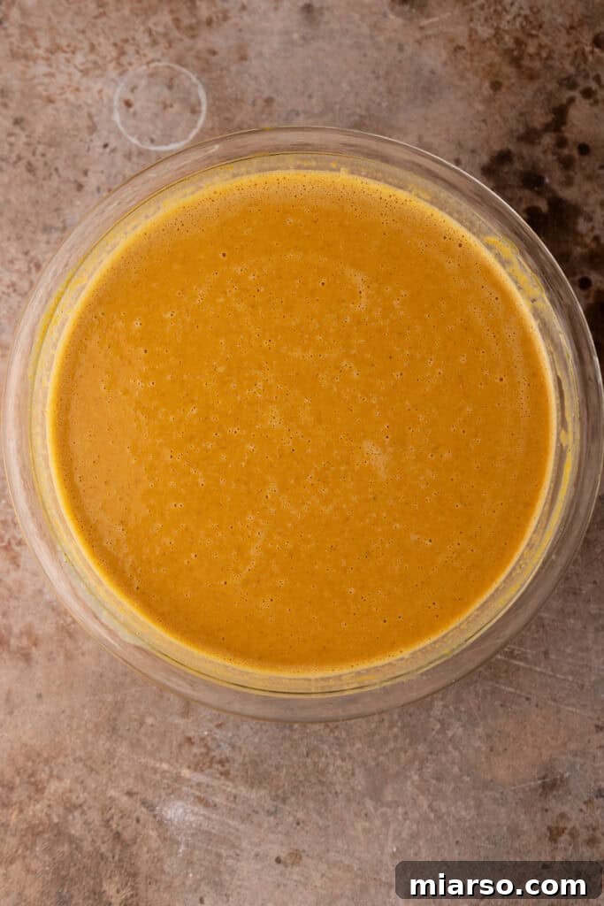 Double the Delight: The Ultimate 9-Inch Pumpkin Pie Recipe 9 The perfectly blended pumpkin pie filling, ready to be poured into pie crusts.