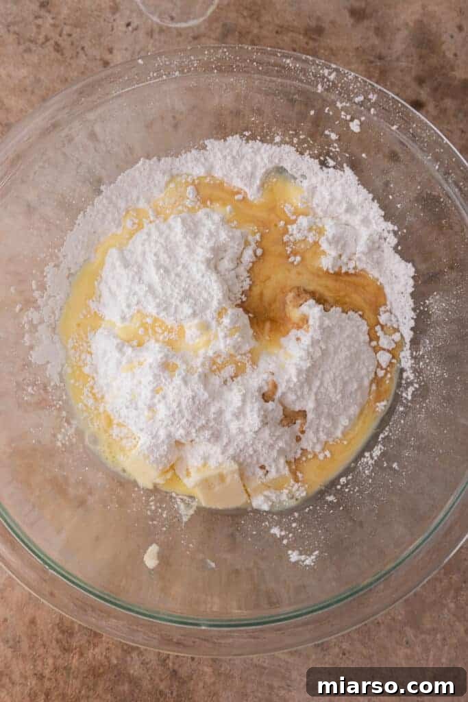 Wet ingredients for frosting in a bowl, before mixing