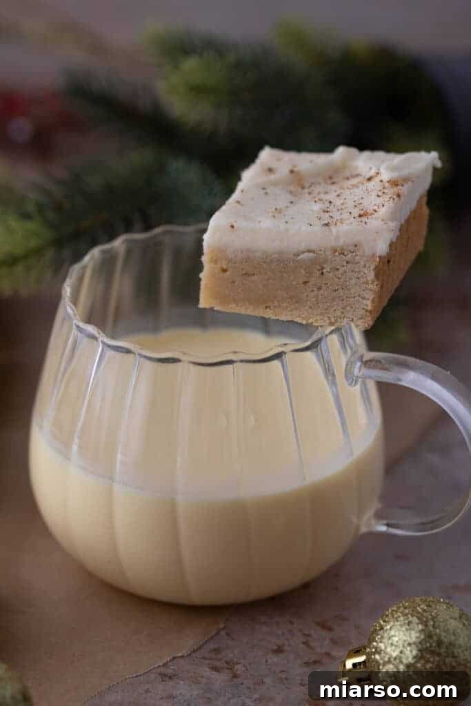 Close-up of frosted eggnog cookie bars on a cooling rack