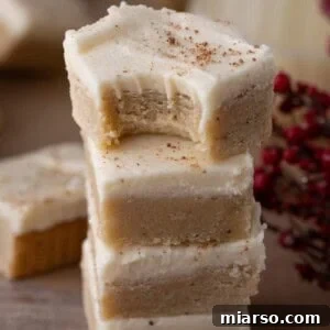 Eggnog cookie bars stacked with frosting