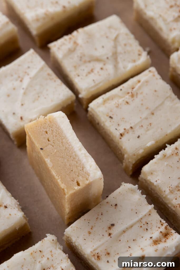 Overhead shot of freshly frosted eggnog cookie bars in a baking pan