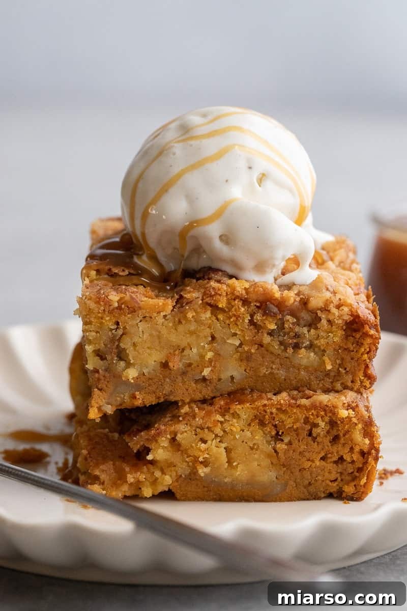 Stack of pumpkin dump cake with ice cream on top