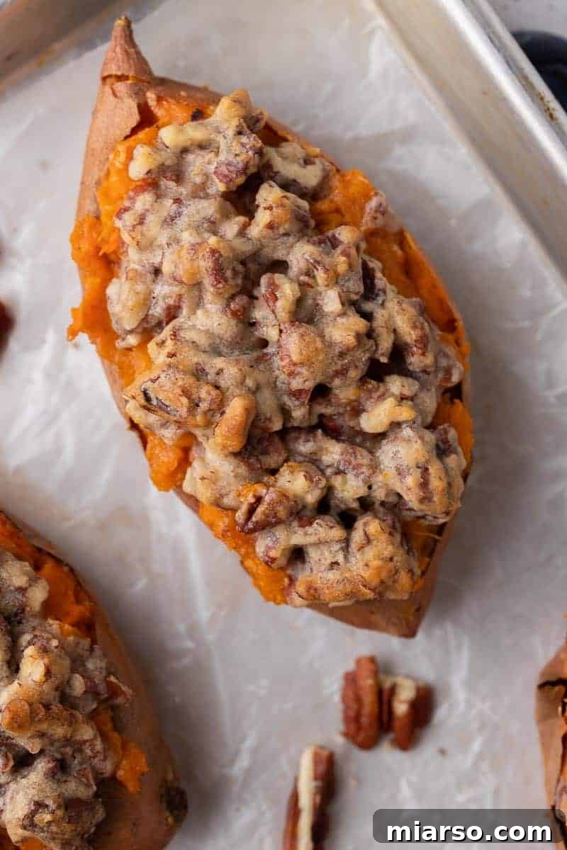 Pecan pie twice baked sweet potato with creamy maple mashed filling and chunky cinnamon pecan streusel baked until golden and bubbling