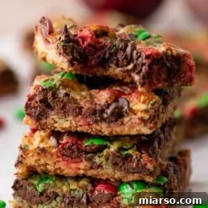 A stack of Christmas magic cookie bars, perfectly baked and garnished