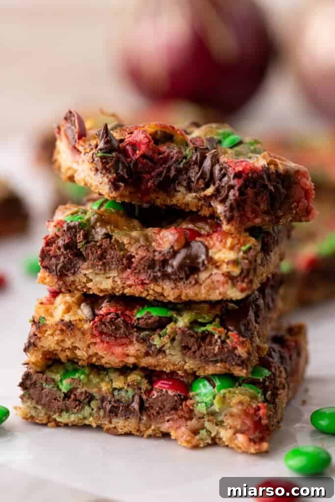 A beautifully arranged stack of Christmas magic cookie bars, ready for serving