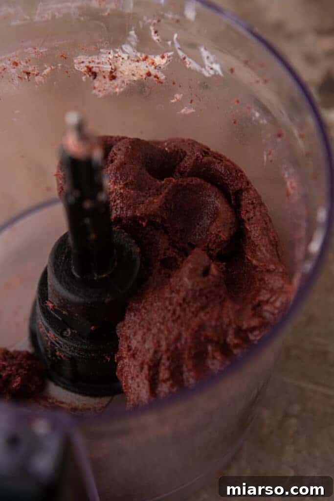 oreo and cream cheese being blended together in a food processor
