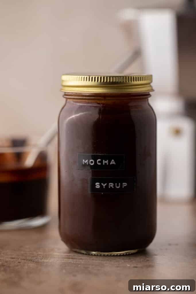 Ultimate Homemade Mocha Coffee Syrup 7 A mason jar full of homemade mocha coffee syrup, ready for storage or use.