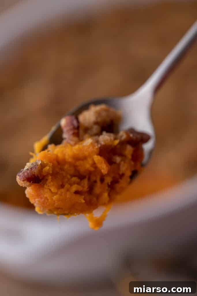 Pecan-Topped Sweet Potato Perfection 4 a spoonful of sweet potato casserole with pecans