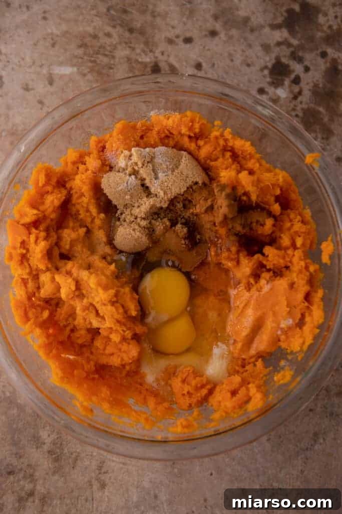 Pecan-Topped Sweet Potato Perfection 9 other unmixed ingredients in the bowl with the potato