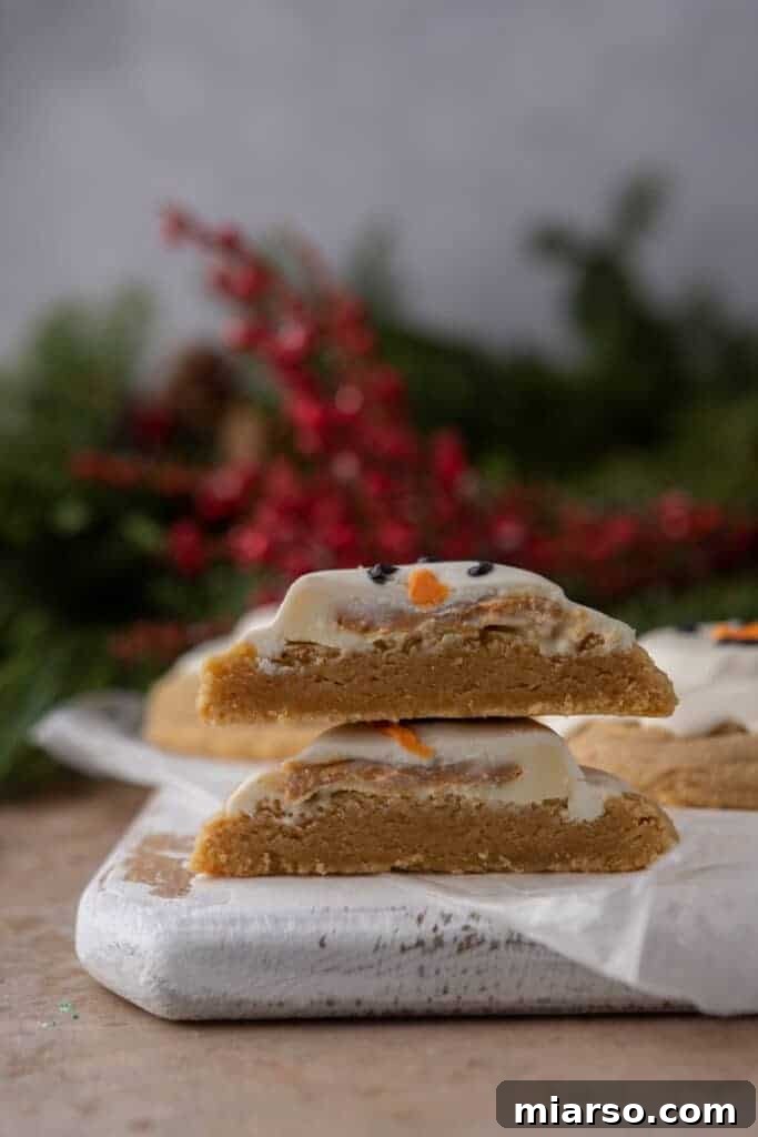 Two halves of a melted snowman peanut butter cookie stacked on top of each other, revealing the delicious layers.