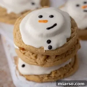 Angled overhead shot of three melted snowman peanut butter cookies