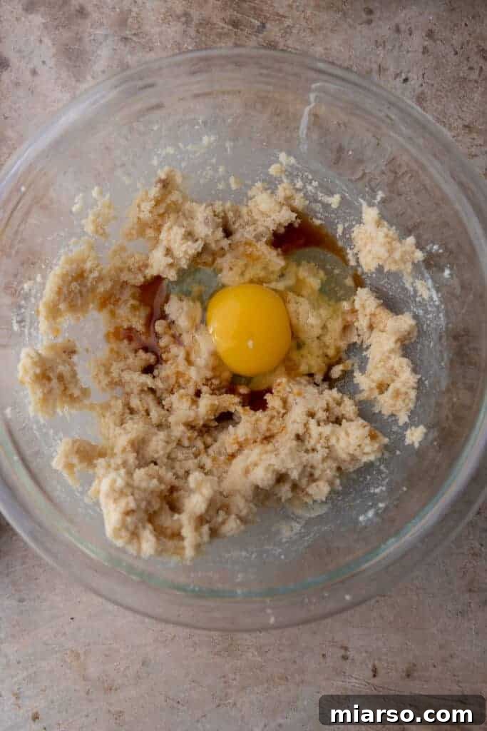 Unmixed ingredients for peanut butter cookies placed into a bowl, ready for combining.