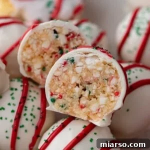 Close-up of a Little Debbie Christmas Tree Cake Truffle split in half, showcasing the colorful, sprinkle-filled center.