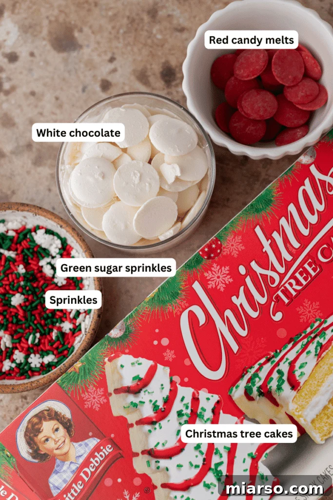 Easy No-Bake Little Debbie Christmas Tree Truffles 3 A collection of ingredients laid out on a surface, ready for making Little Debbie Christmas Tree Cake Truffles, including cakes, chocolates, and sprinkles.