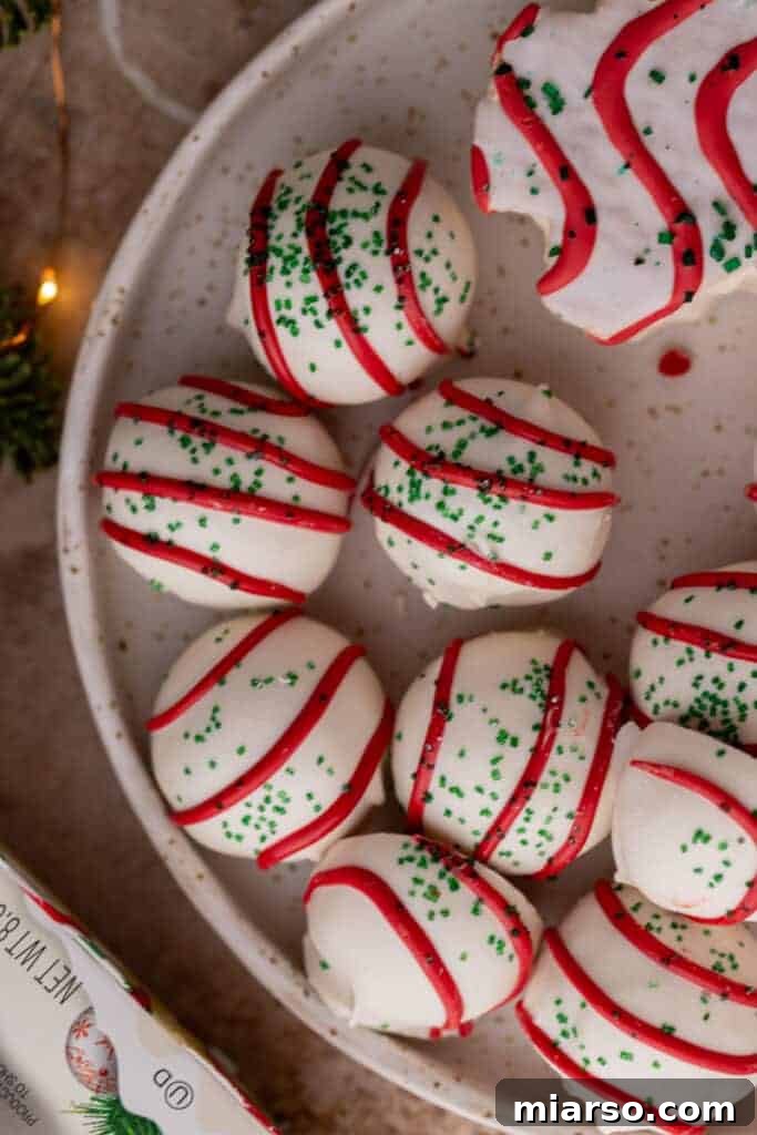 Easy No-Bake Little Debbie Christmas Tree Truffles 4 A charming close-up of multiple finished Little Debbie Christmas Tree Cake Truffles presented elegantly in a bowl.